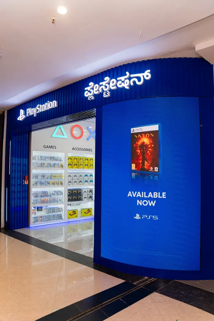 Blue PlayStation Exclusive storefront at Phoenix Marketcity with the PlayStation sign in English and Kannada
